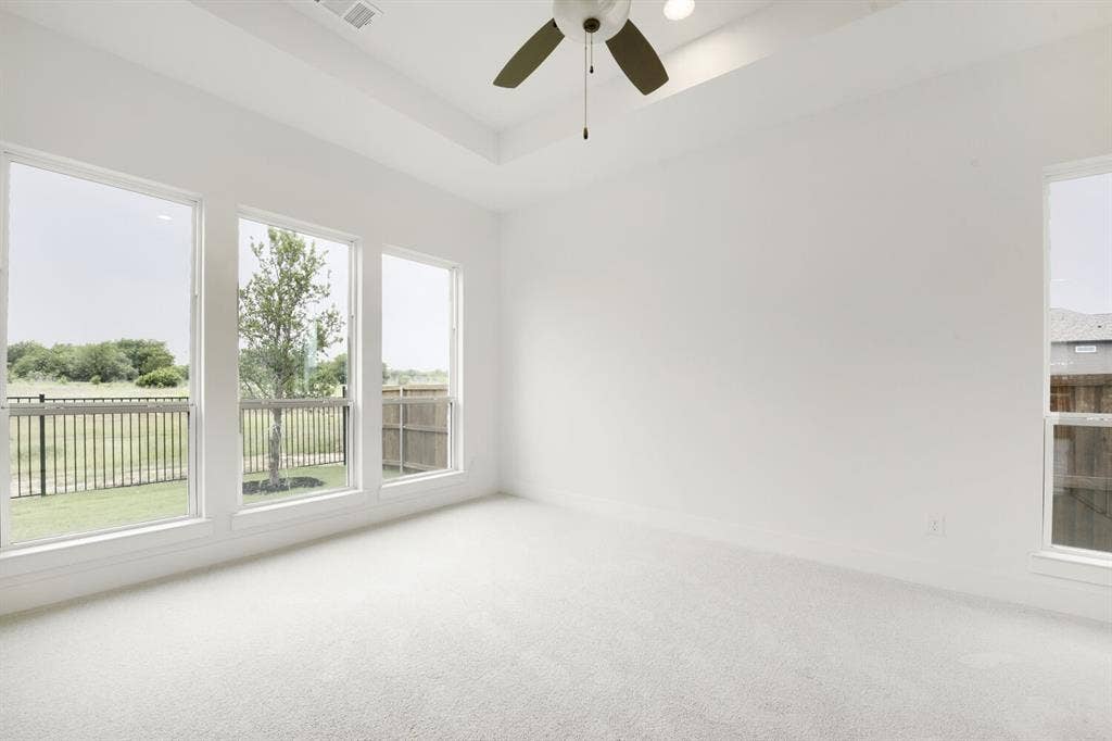 733 Red Cedar Road, Haslet, TX 76052 Spacious room featuring a tray ceiling, ceiling fan with integrated lighting, recessed lighting, and light-toned carpet flooring