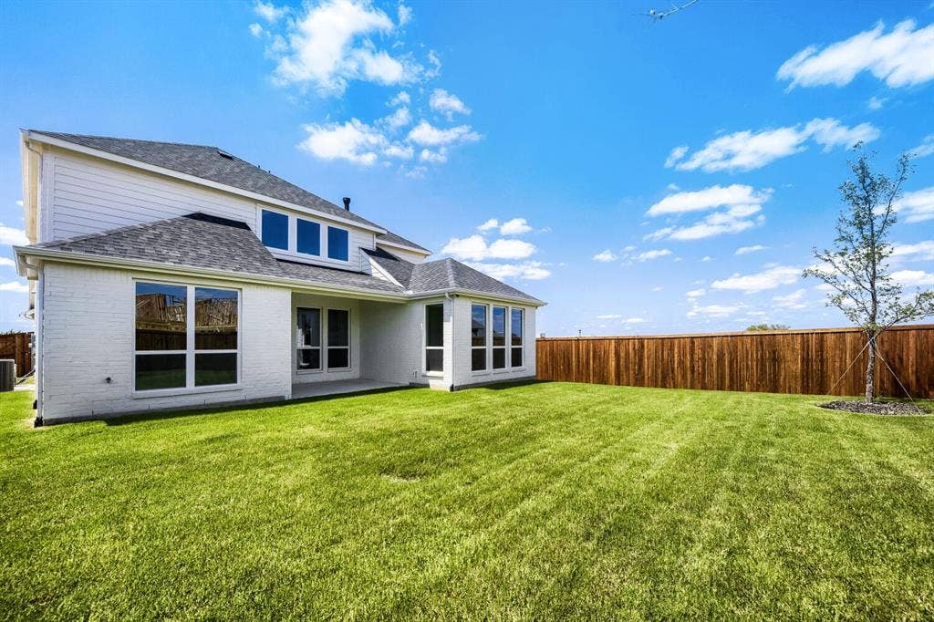 1241 Greenbriar Avenue, Haslet, TX 76052 Expansive green lawn bordering a white brick and siding exterior