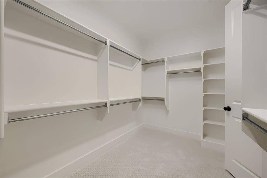 1241 Greenbriar Avenue, Haslet, TX 76052 Custom closet system featuring multiple hanging rods, built-in shelving, and white interior finishes