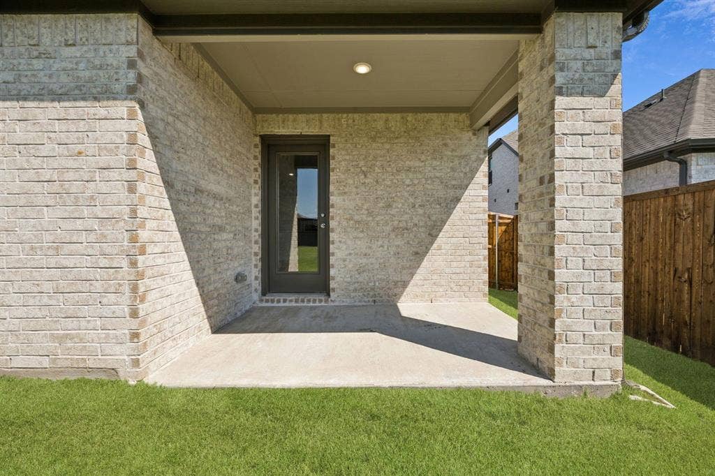 201 Bright Alcove Court, Lavon, TX 75166 Covered Patio in the Heisman home plan by Trophy Signature Homes – REPRESENTATIVE PHOTO