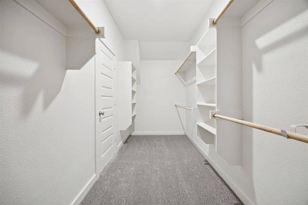 201 Bright Alcove Court, Lavon, TX 75166 Primary Closet in the Heisman home plan by Trophy Signature Homes – REPRESENTATIVE PHOTO