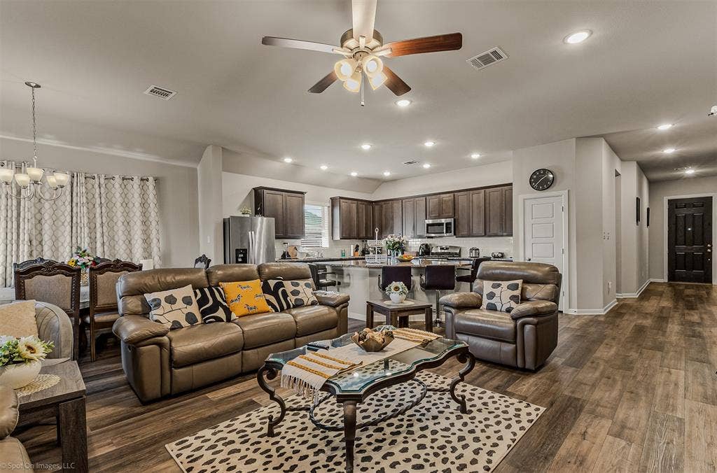 5408 Wedge Wood Drive, Haltom City, TX 76137 Living room with a chandelier, a ceiling fan, and dark wood-style flooring