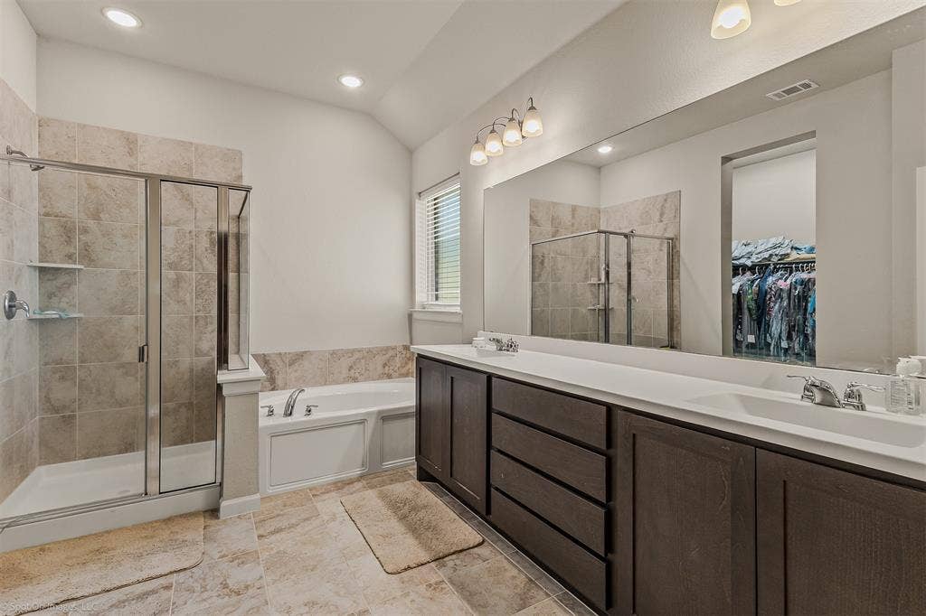 5408 Wedge Wood Drive, Haltom City, TX 76137 Full bath featuring double vanity, a spacious closet, a stall shower, a bath, and lofted ceiling