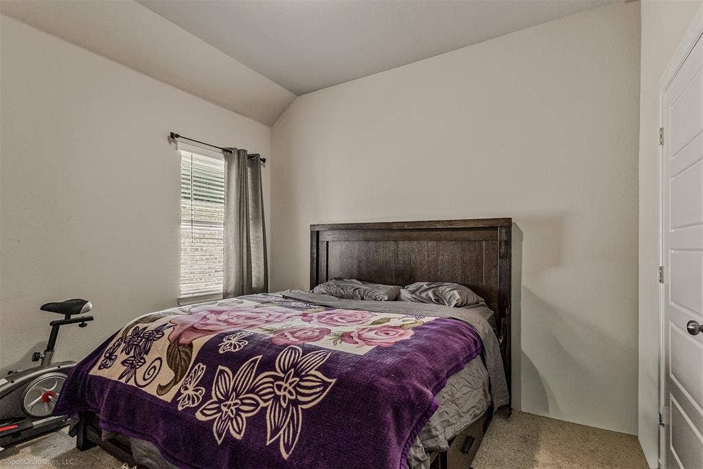 5408 Wedge Wood Drive, Haltom City, TX 76137 Bedroom with light carpet and lofted ceiling