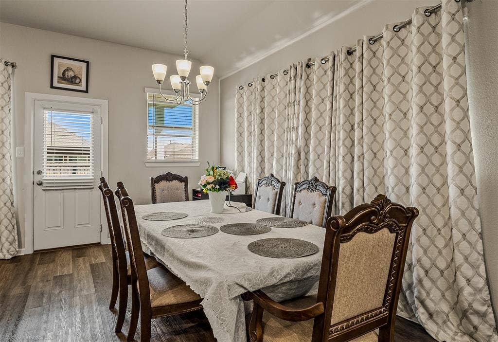 5408 Wedge Wood Drive, Haltom City, TX 76137 Dining area featuring a chandelier and dark wood finished floors