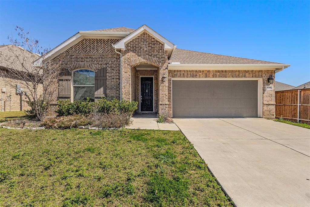 5408 Wedge Wood Drive, Haltom City, TX 76137 View of front of property featuring brick siding, an attached garage, driveway, and a shingled roof