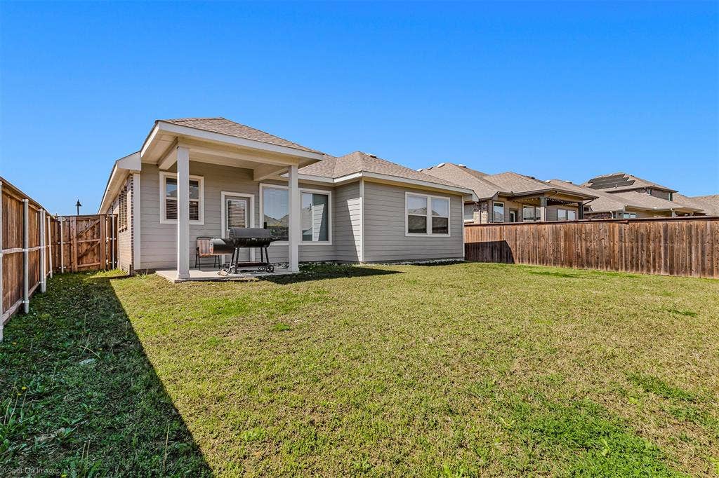 5408 Wedge Wood Drive, Haltom City, TX 76137 Rear view of house featuring a patio, a fenced backyard, roof with shingles, and a gate