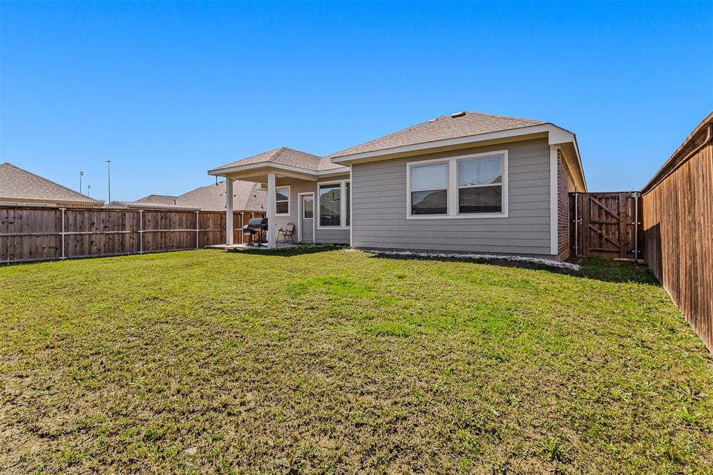 5408 Wedge Wood Drive, Haltom City, TX 76137 Rear view of property featuring a patio area, a gate, a fenced backyard, and roof with shingles