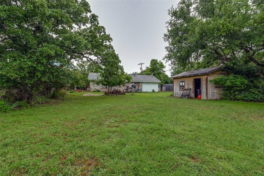 View of grassy yard with an outdoor structure