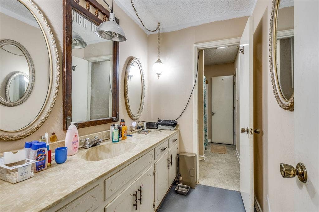 Bathroom featuring a textured ceiling and vanity