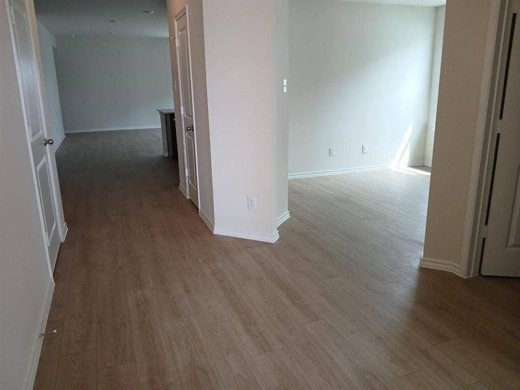 315 Whispering Pine Drive, Royse City, TX 75189 Light wood-finish flooring throughout, complemented by white baseboards and neutral wall tones
