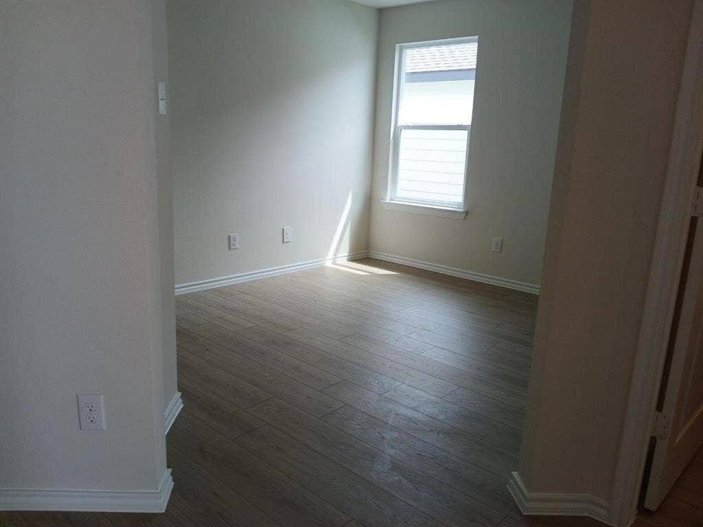 315 Whispering Pine Drive, Royse City, TX 75189 Room featuring wood-finish flooring, white baseboards, and neutral wall paint