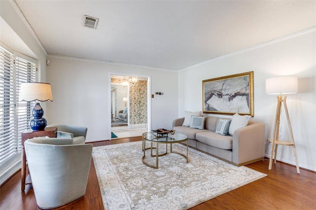 14810 Knollview Drive, Dallas, TX 75248 Living room featuring wood finished floors, suspended lighting, and ornamental molding