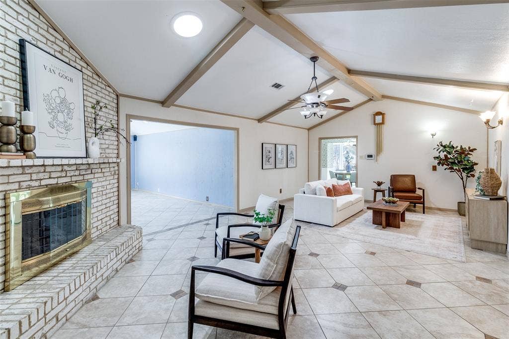 14810 Knollview Drive, Dallas, TX 75248 Living room featuring a brick fireplace, light tile patterned floors, a ceiling fan, and beam ceiling
