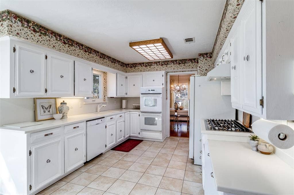 14810 Knollview Drive, Dallas, TX 75248 Kitchen with light countertops, white cabinets, white appliances, hanging lights, and light tile patterned floors