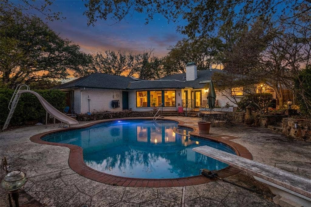 14810 Knollview Drive, Dallas, TX 75248 Back of property featuring a patio, an outdoor pool, and a chimney