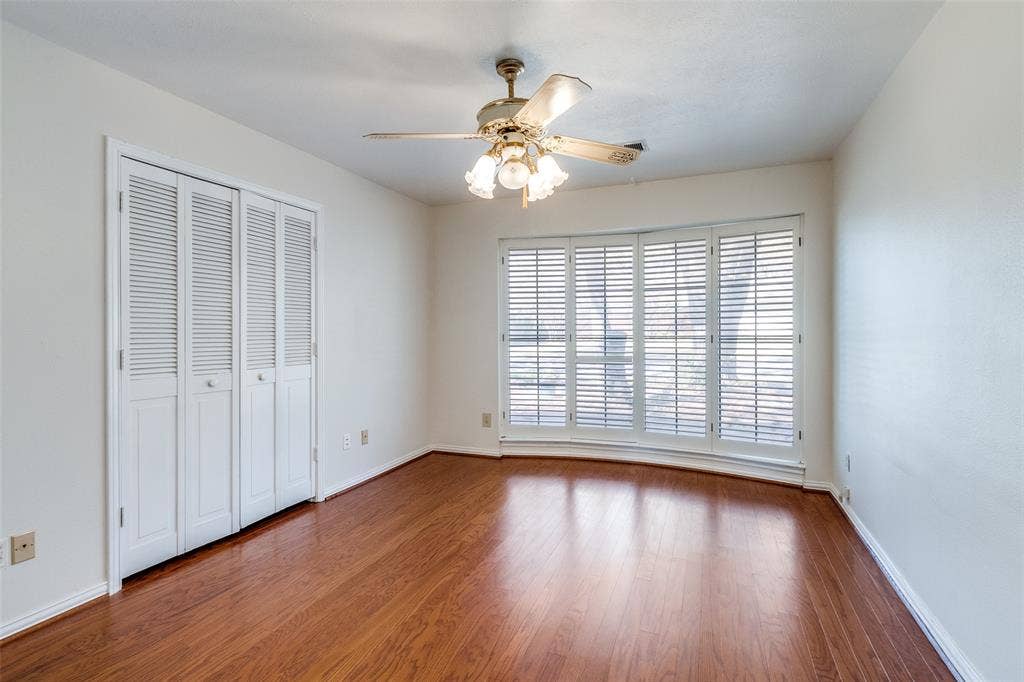 14810 Knollview Drive, Dallas, TX 75248 Unfurnished bedroom with a closet, dark wood-type flooring, and a ceiling fan