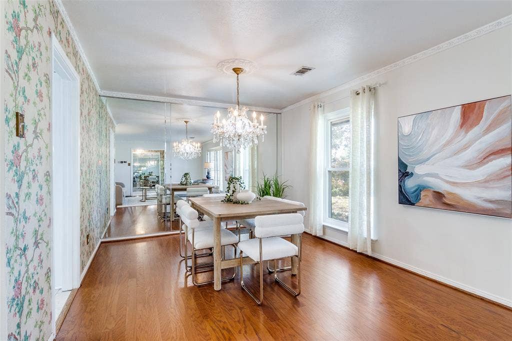 14810 Knollview Drive, Dallas, TX 75248 Dining space featuring wood finished floors, crown molding, and suspended lighting