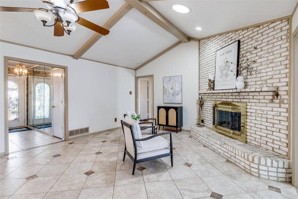 14810 Knollview Drive, Dallas, TX 75248 Living area featuring a fireplace, hanging lights, beamed ceiling, light tile patterned floors, and ceiling fan