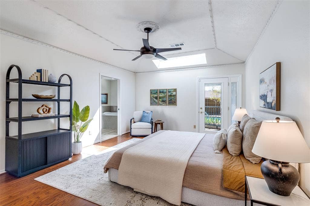 14810 Knollview Drive, Dallas, TX 75248 Bedroom featuring access to exterior, a ceiling fan, wood finished floors, connected bathroom, and vaulted ceiling