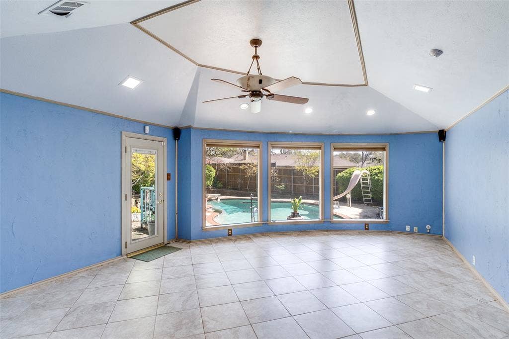 14810 Knollview Drive, Dallas, TX 75248 Spare room with a ceiling fan, vaulted ceiling, and light tile patterned floors