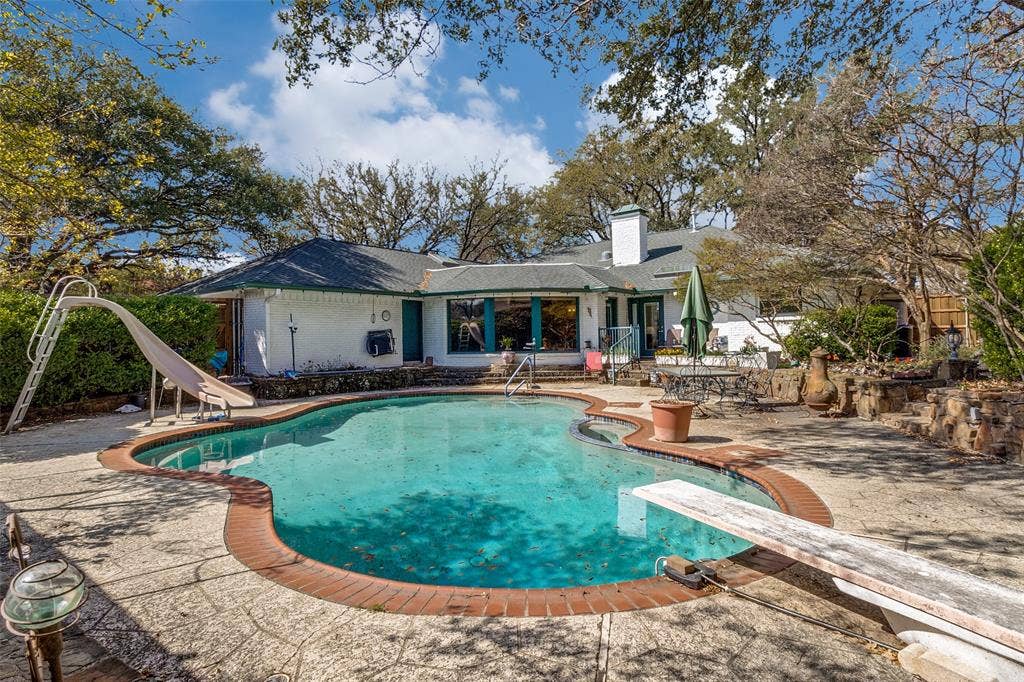 14810 Knollview Drive, Dallas, TX 75248 Back of property featuring a patio, an outdoor pool, brick siding, and a chimney