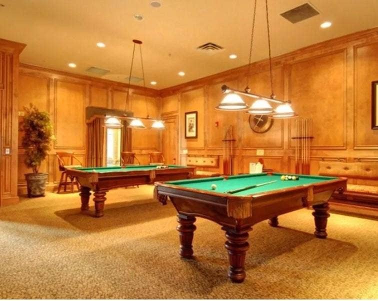 351 Southern Hills Drive, Fairview, TX 75069 Recreation room featuring two billiard tables, wood paneling with decorative trim, recessed lighting, and patterned carpeting