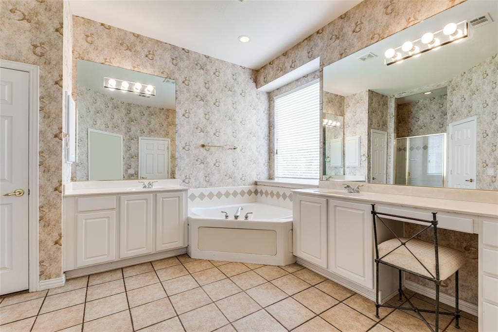 351 Southern Hills Drive, Fairview, TX 75069 Primary bathroom featuring two vanities, light tile patterned floors, a bath, a walk-in shower, and recessed lighting