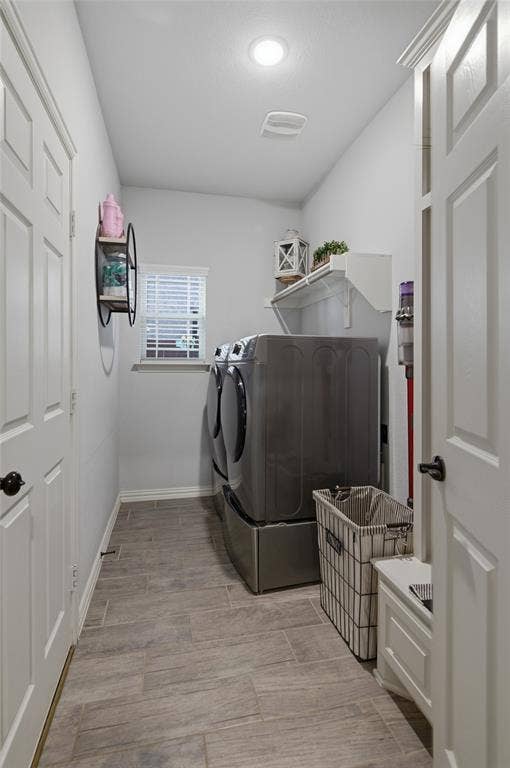 Utility room featuring wood-look tile flooring and a window with blinds