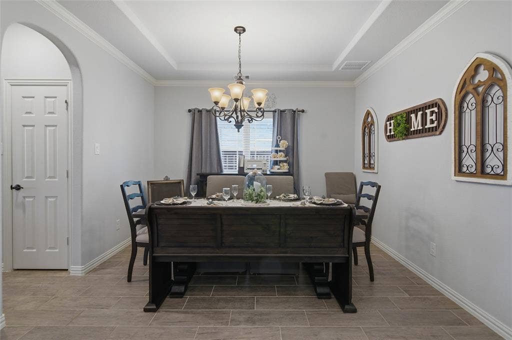Dining space featuring wood-finish tile flooring and light gray wall tones