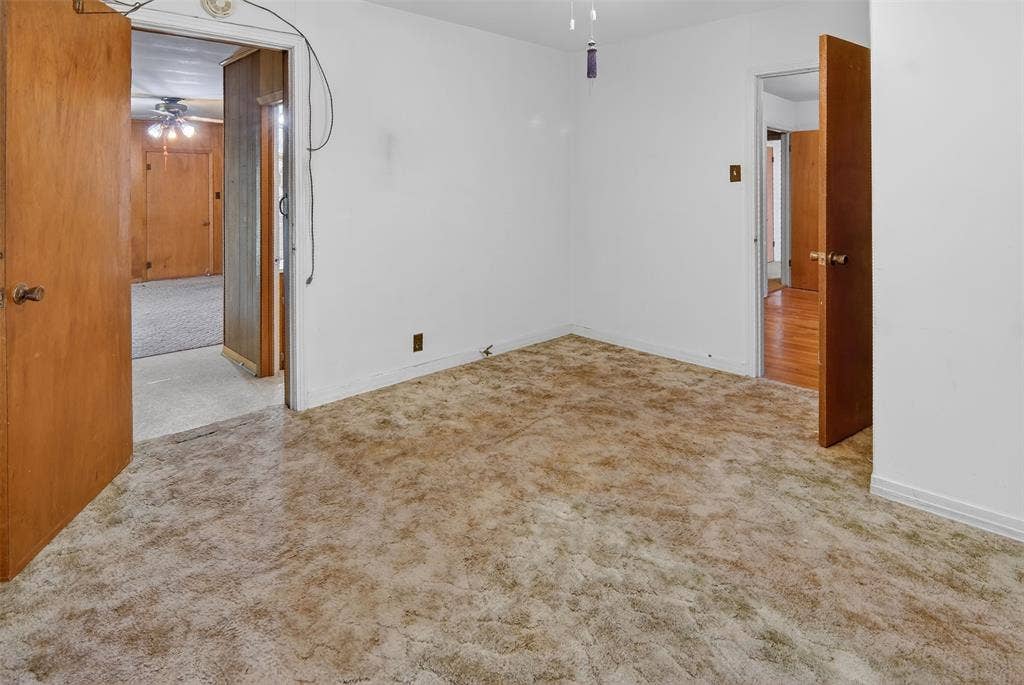 1224 S Brazos Street, Weatherford, TX 76086 Second bedroom features carpet and ceiling fan.