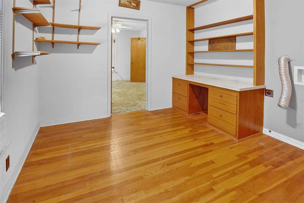 1224 S Brazos Street, Weatherford, TX 76086 First bedroom features built in desk and shelving, and wood type flooring. Space for stackable washer and dryer with connections in place.
