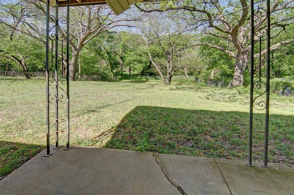 1224 S Brazos Street, Weatherford, TX 76086 View of large backyard with lots of tall shade trees.