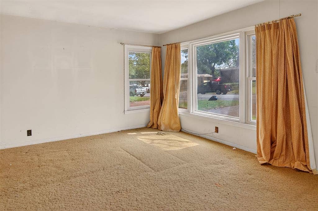 1224 S Brazos Street, Weatherford, TX 76086 Living area with large windows that allow plenty of natural light.