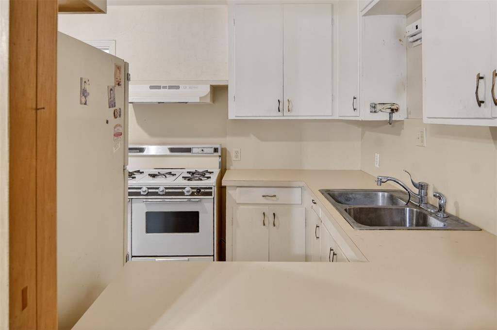 1224 S Brazos Street, Weatherford, TX 76086 View of kitchen from den through pass-through opening.