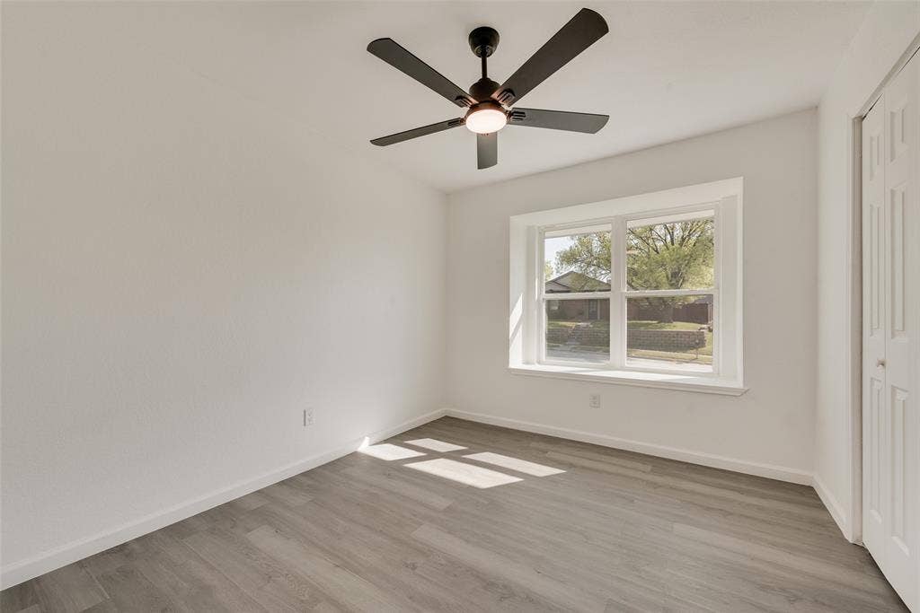3217 Mahan Circle, Mesquite, TX 75149 Unfurnished bedroom featuring a closet, light wood-style flooring, and a ceiling fan