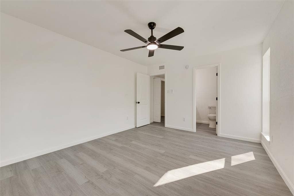 3217 Mahan Circle, Mesquite, TX 75149 Unfurnished bedroom with ceiling fan, light wood-style flooring, and ensuite bath