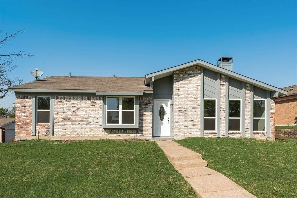 3217 Mahan Circle, Mesquite, TX 75149 View of front of property featuring a chimney, a front yard, and brick siding