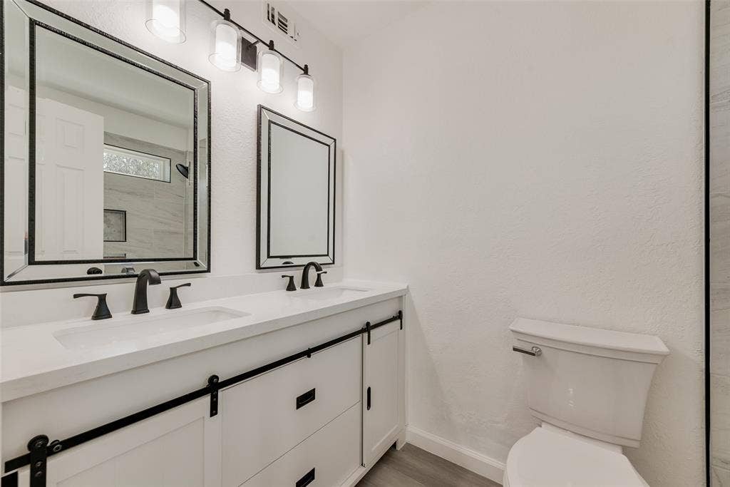 3217 Mahan Circle, Mesquite, TX 75149 Bathroom featuring double vanity and light wood-style flooring