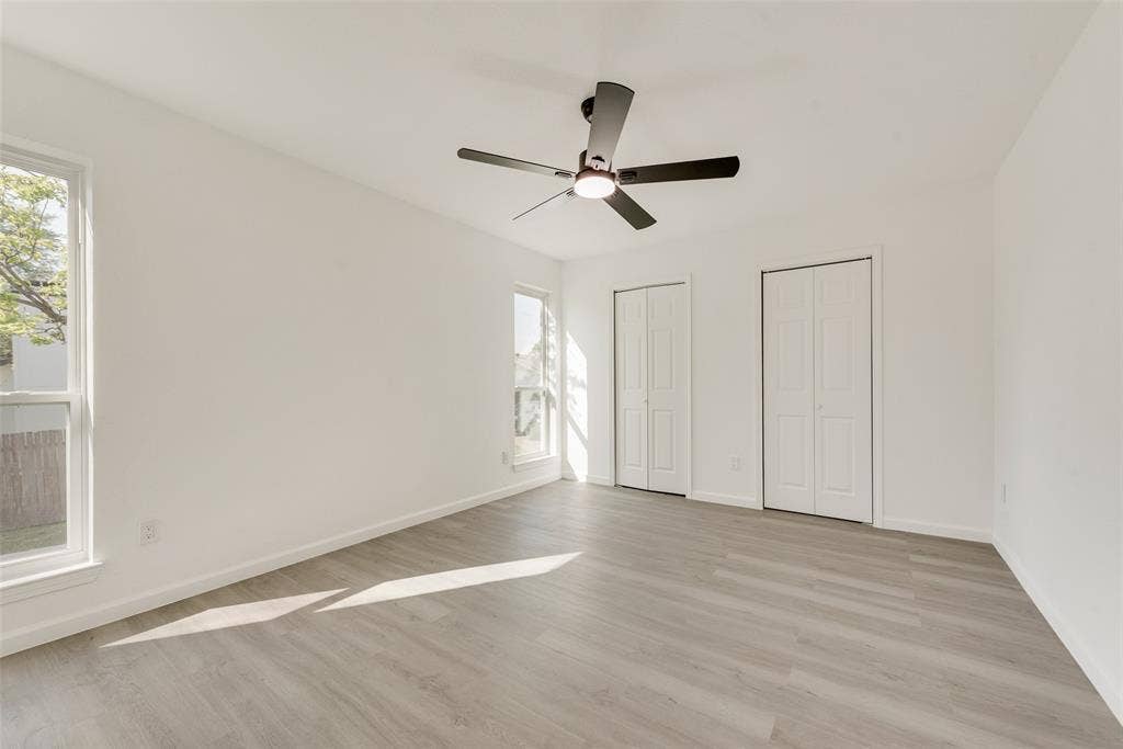3217 Mahan Circle, Mesquite, TX 75149 Unfurnished bedroom with multiple closets, light wood-style flooring, and ceiling fan