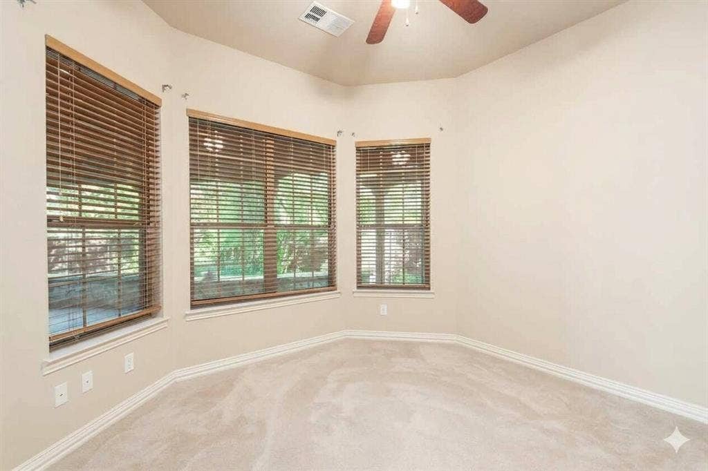 15031 Woodbluff Drive, Frisco, TX 75035 Bay window with natural wood blinds, vaulted ceiling, ceiling fan, and light-toned carpet