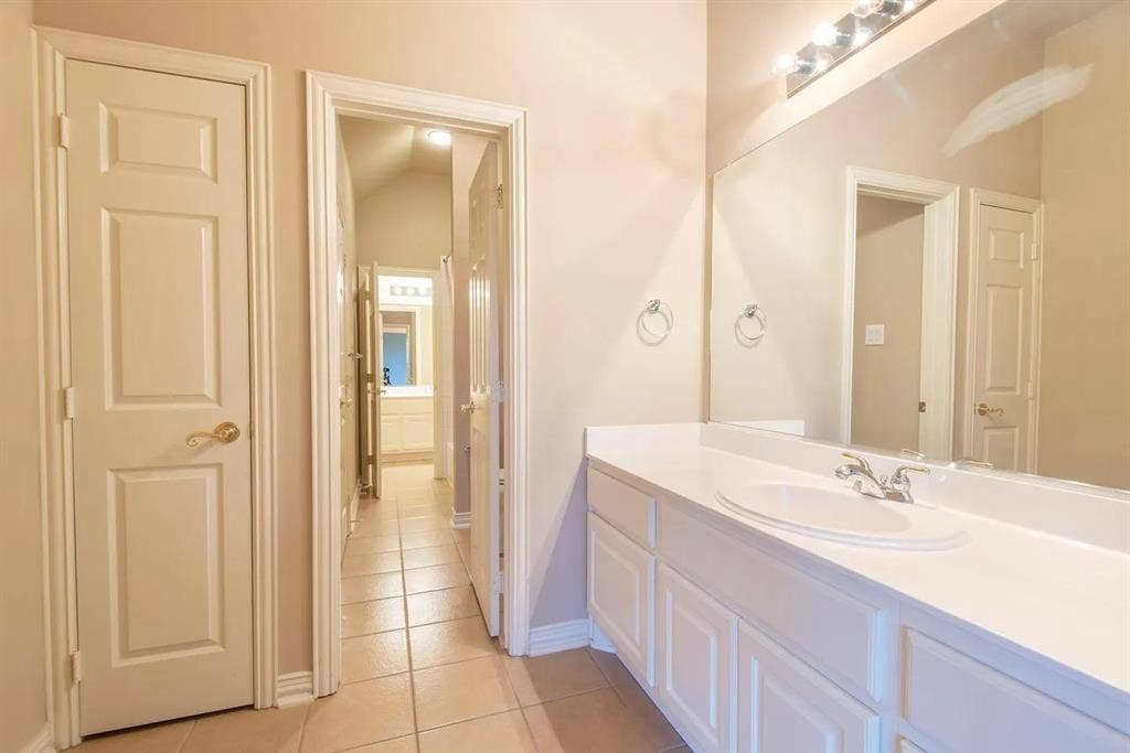 15031 Woodbluff Drive, Frisco, TX 75035 White vanity with integrated sink and chrome faucet
