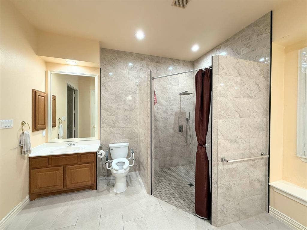15031 Woodbluff Drive, Frisco, TX 75035 Spacious bathroom featuring a large walk-in shower with tiled walls and a rain showerhead