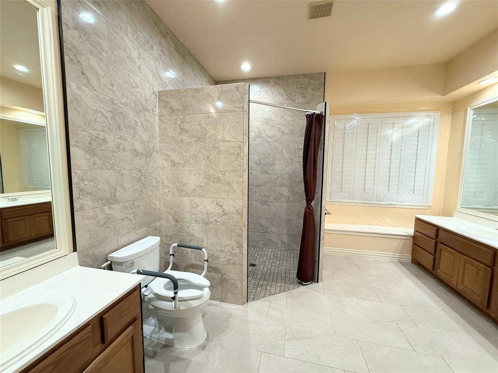 15031 Woodbluff Drive, Frisco, TX 75035 Spacious bathroom featuring an oversized walk-in shower with large format tile surround and mosaic tile flooring