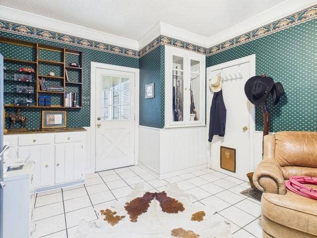 2382 Crystal Drive, Athens, TX 75752 Entryway featuring ornamental molding, light tile patterned floors, and wallpapered walls