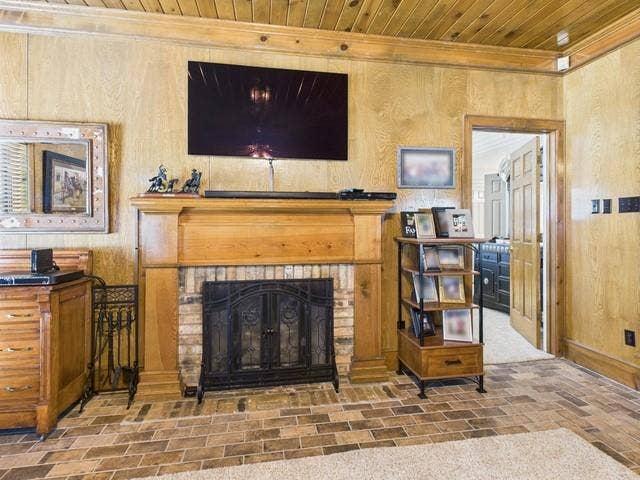 2382 Crystal Drive, Athens, TX 75752 Detailed view of a fireplace, crown molding, wooden ceiling, and wood walls