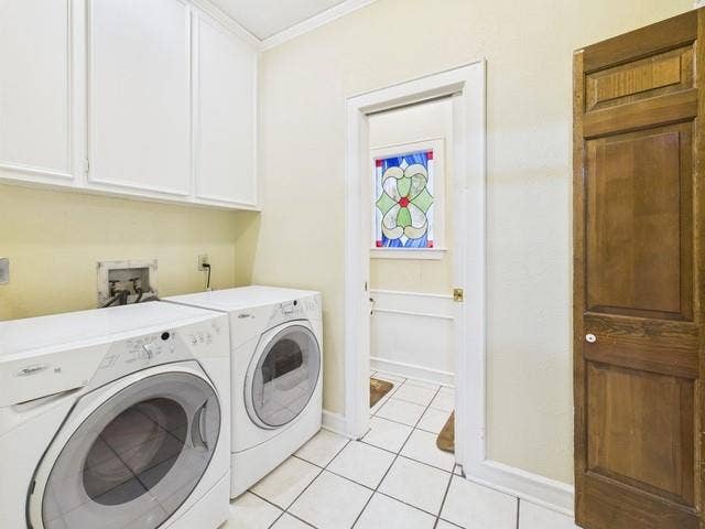 2382 Crystal Drive, Athens, TX 75752 Laundry area with cabinet space, washer and dryer, ornamental molding, and light tile patterned flooring