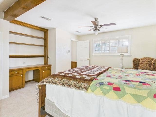 2382 Crystal Drive, Athens, TX 75752 Bedroom with light carpet, built in study area, and a ceiling fan