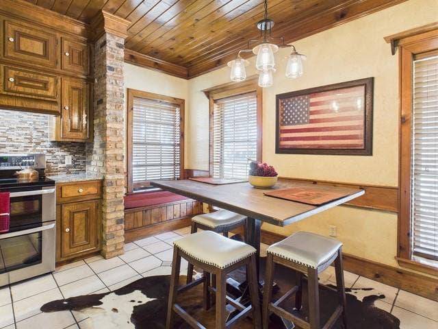 2382 Crystal Drive, Athens, TX 75752 Dining area with light tile patterned floors, wood ceiling, and ornamental molding
