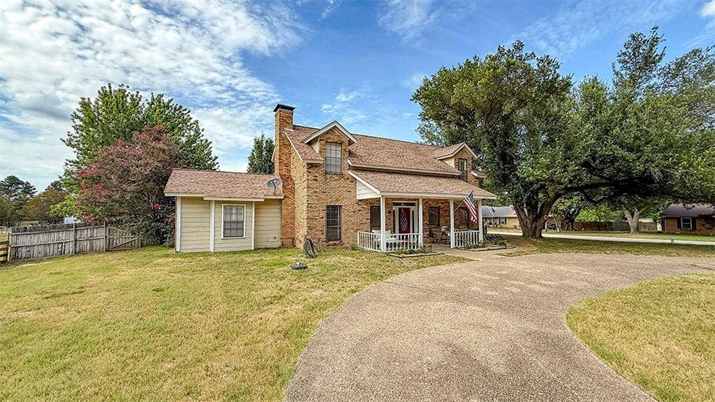 2382 Crystal Drive, Athens, TX 75752 View of front of house with covered porch, a chimney, and driveway
